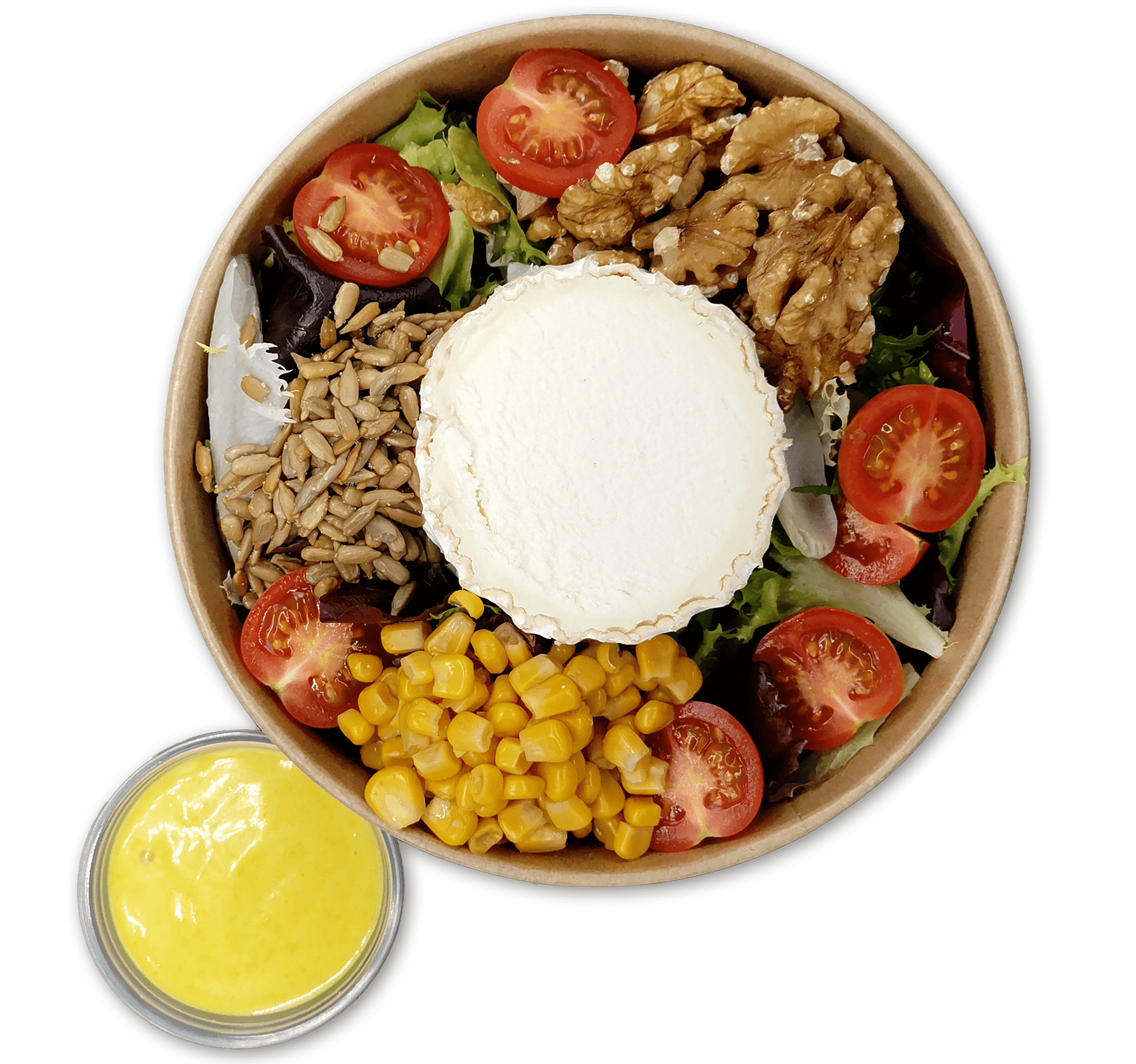 Un tazón de ensalada de rulo de cabra que incluye una rebanada redonda central de queso rulo de cabra, rodeada de tomates cherry cortados por la mitad, nueces, semillas de girasol, maíz y verduras de hoja verde mixtas. Un pequeño recipiente de aderezo amarillo acompaña el tazón.